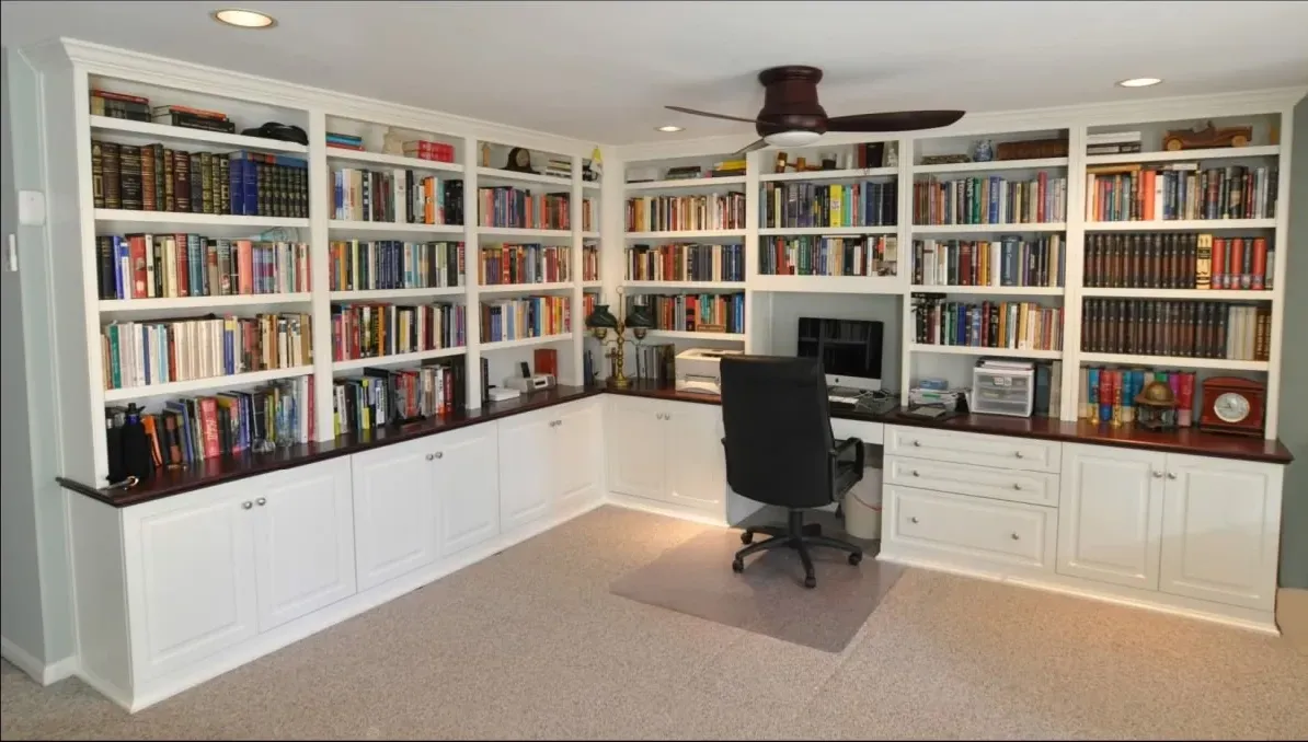 A library with lots of books and a desk