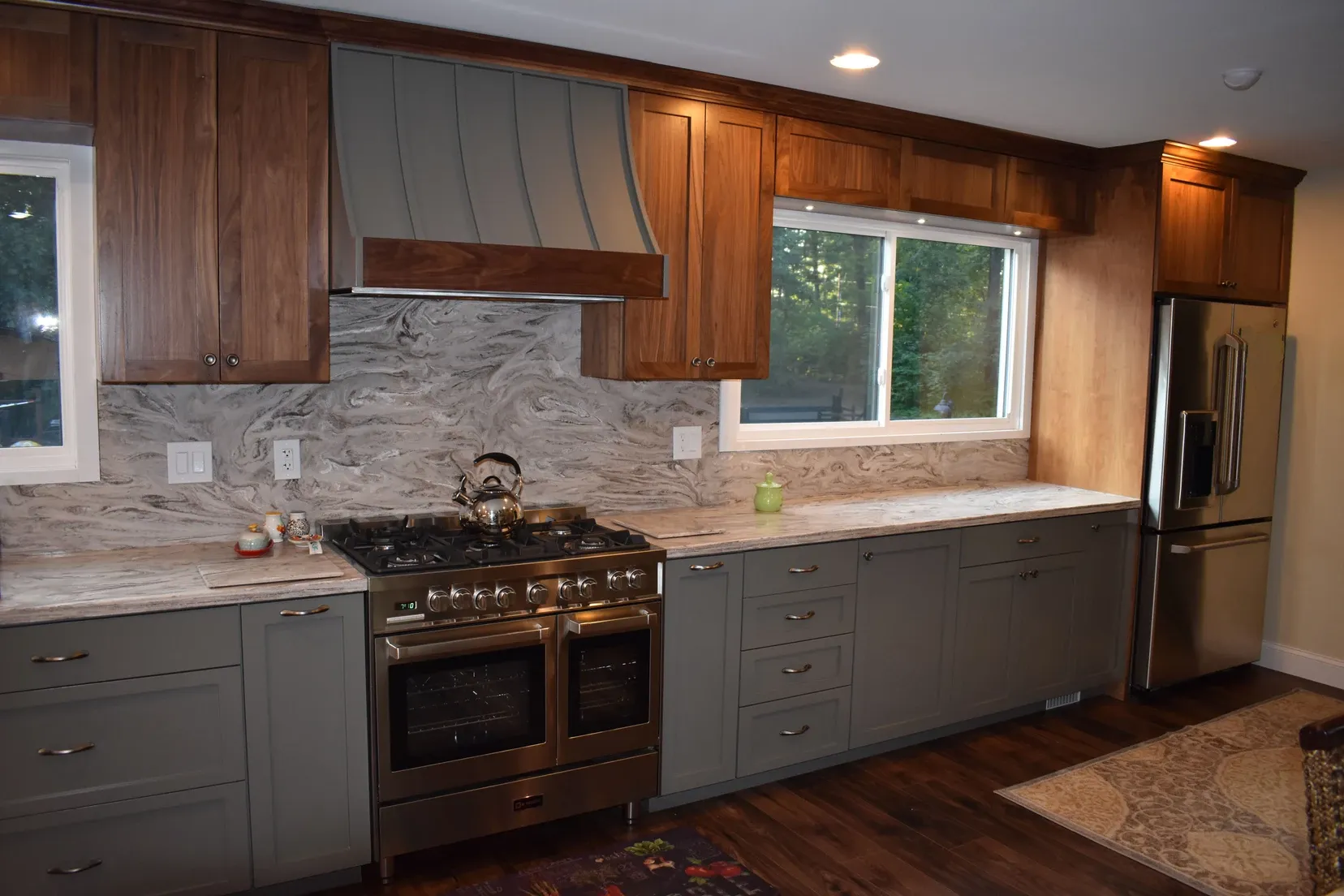 A kitchen with stainless steel appliances and wooden cabinets