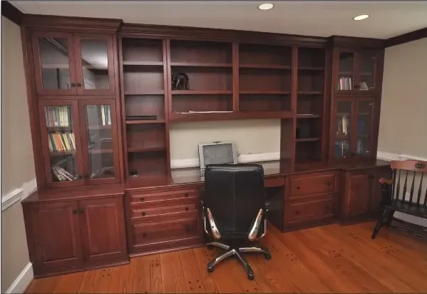 A desk with a computer on it and a chair in front of it