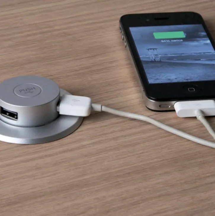 A cell phone is being charged by a usb charger