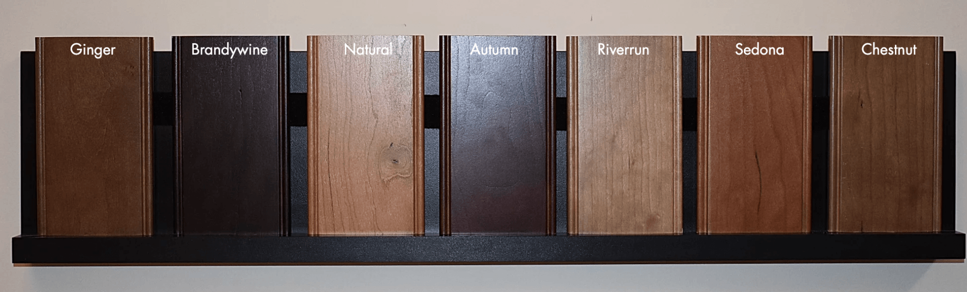 A row of different colored wood samples on a shelf