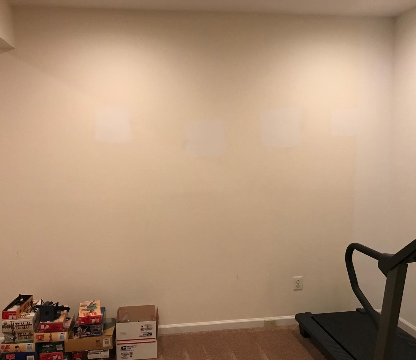 An empty room with a treadmill and boxes on the floor
