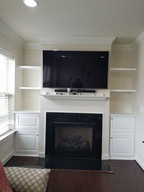 A living room with a fireplace and a flat screen tv
