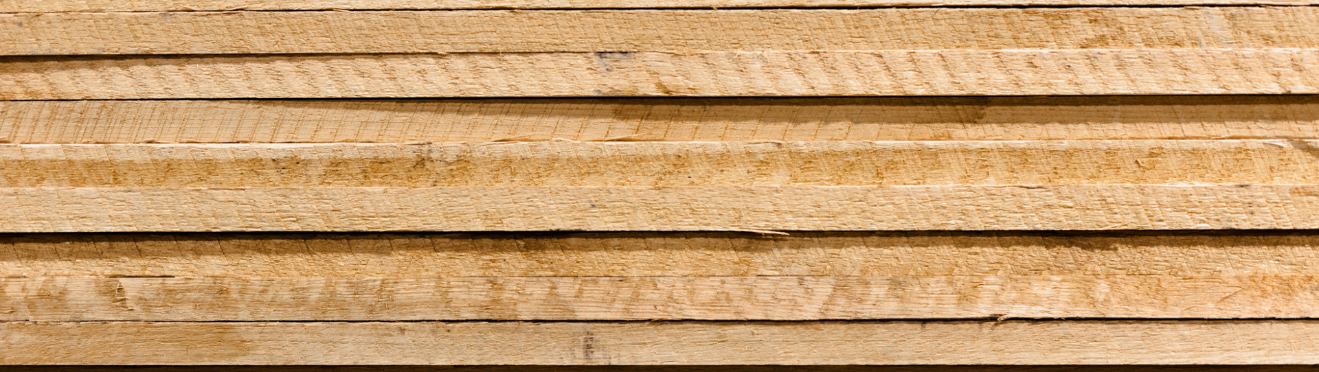 A close up of a stack of wooden boards.