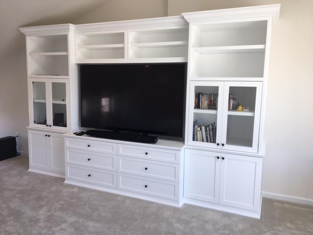 A large entertainment center with a flat screen tv