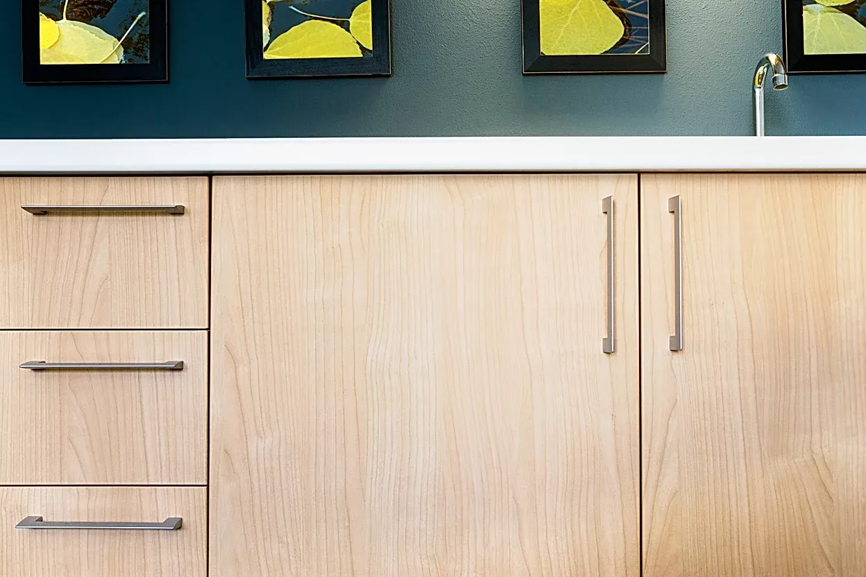 A kitchen with wooden cabinets and a sink