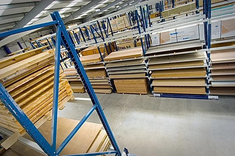 A warehouse filled with lots of wooden shelves
