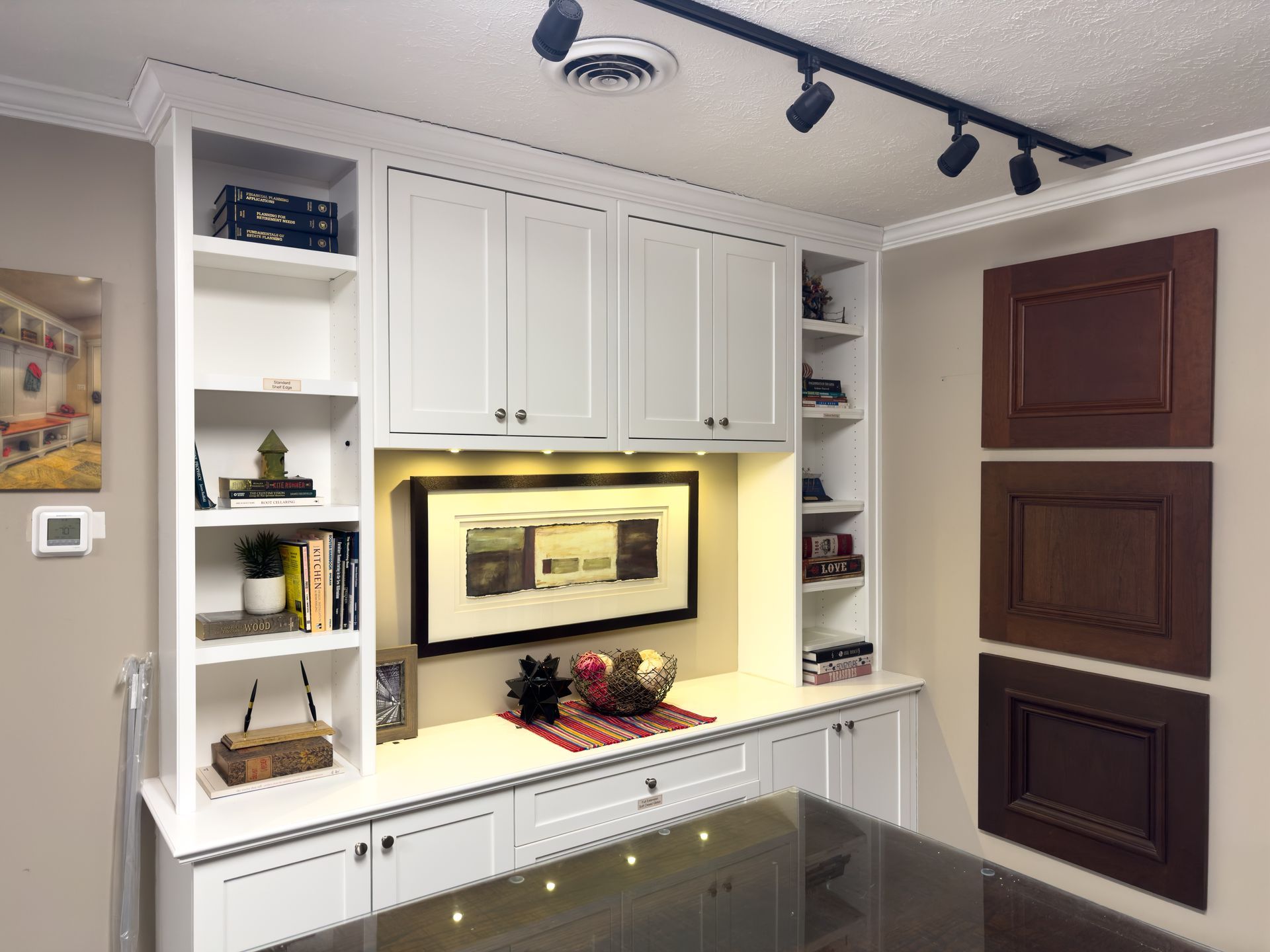A room with white cabinets and a picture on the wall