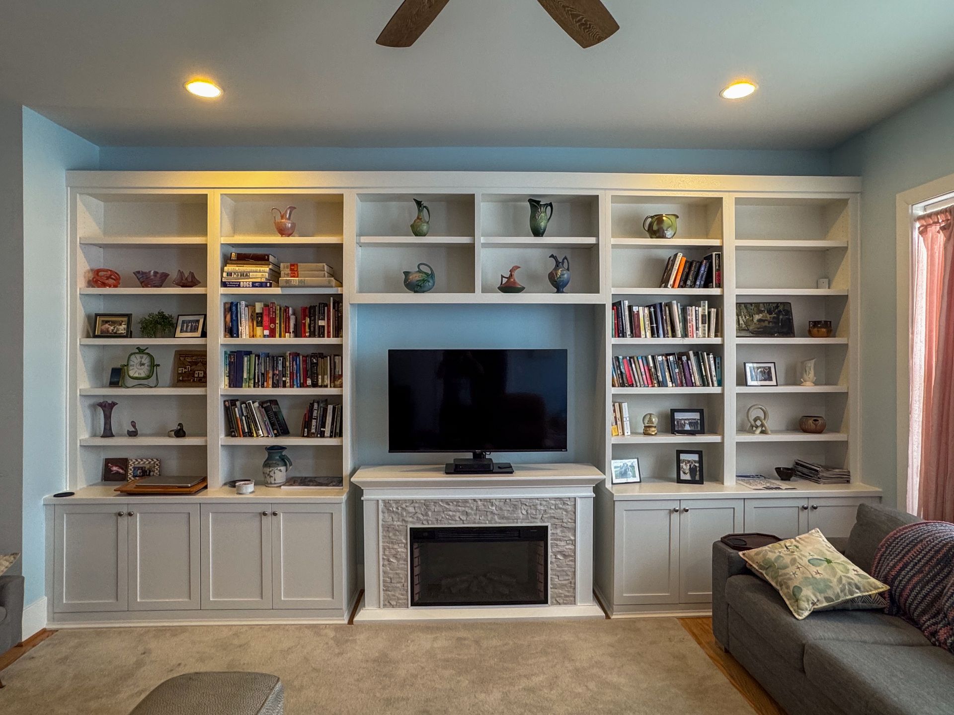 A living room with a large flat screen tv on the wall