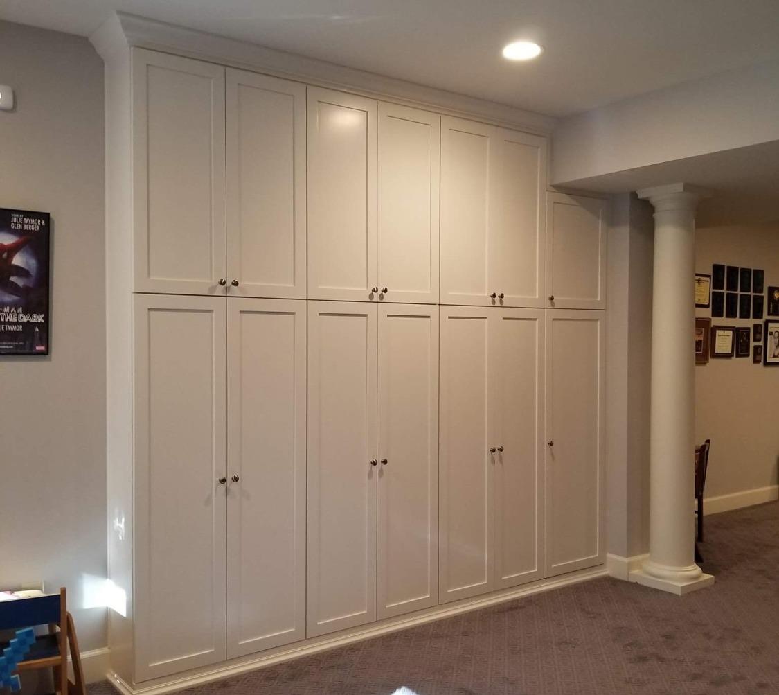 A room with white cabinets and a poster on the wall that says ' a few weeks ago '