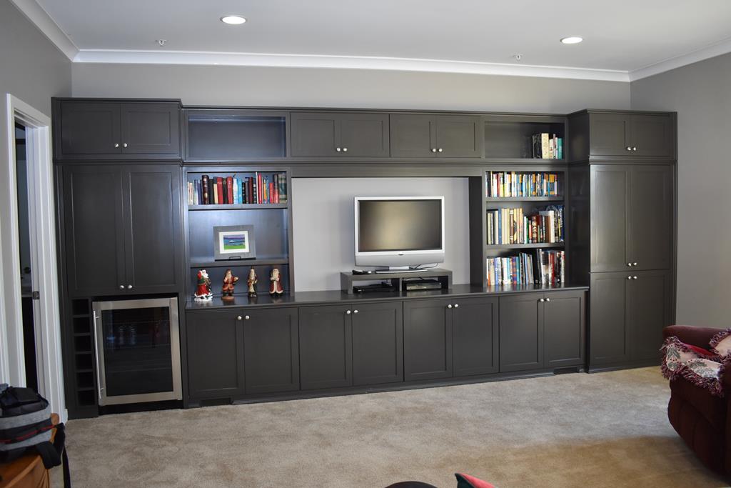 A living room with black cabinets and a flat screen tv