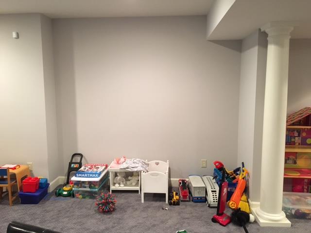 A basement with a lot of toys on the floor