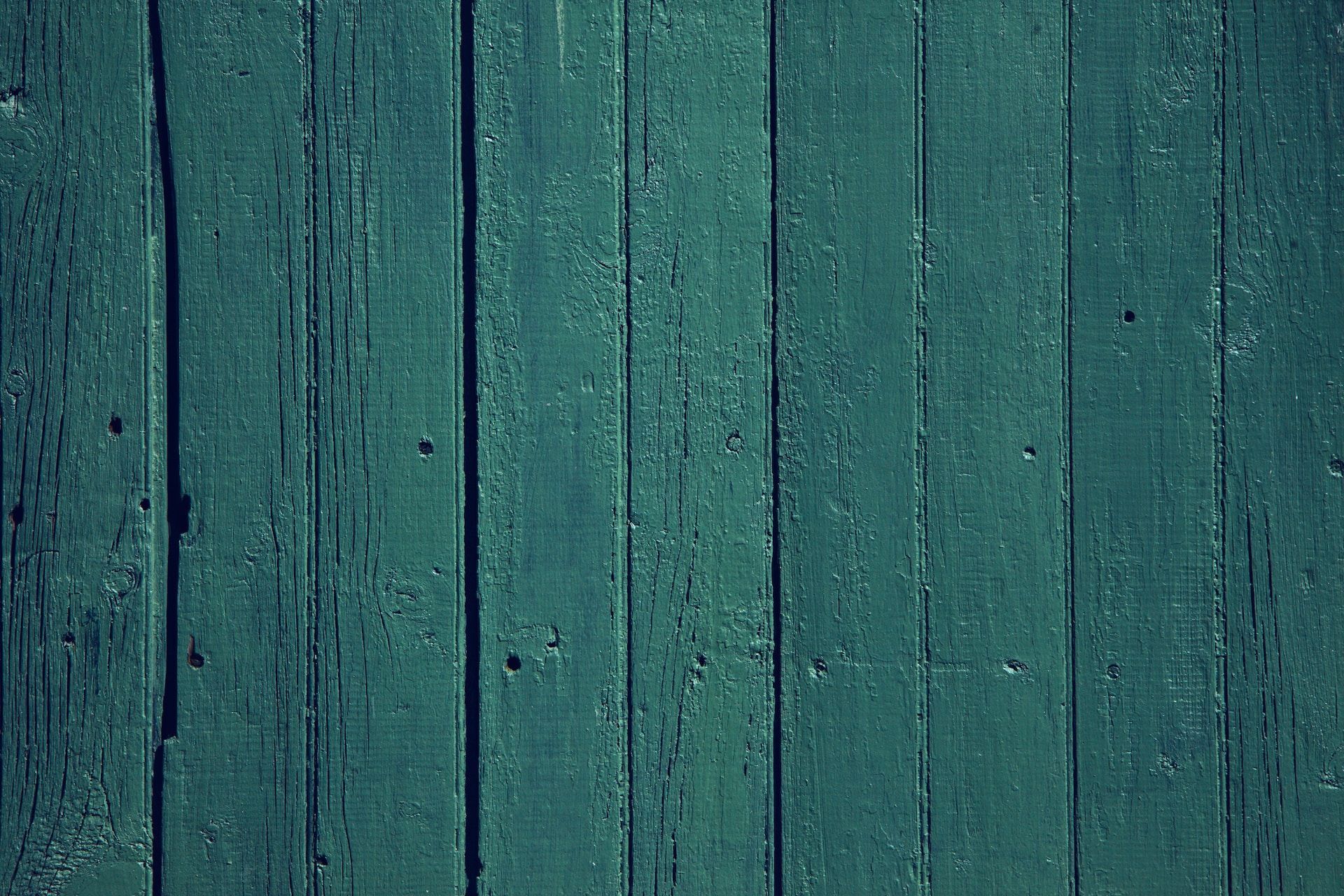 A close up of a green wooden wall