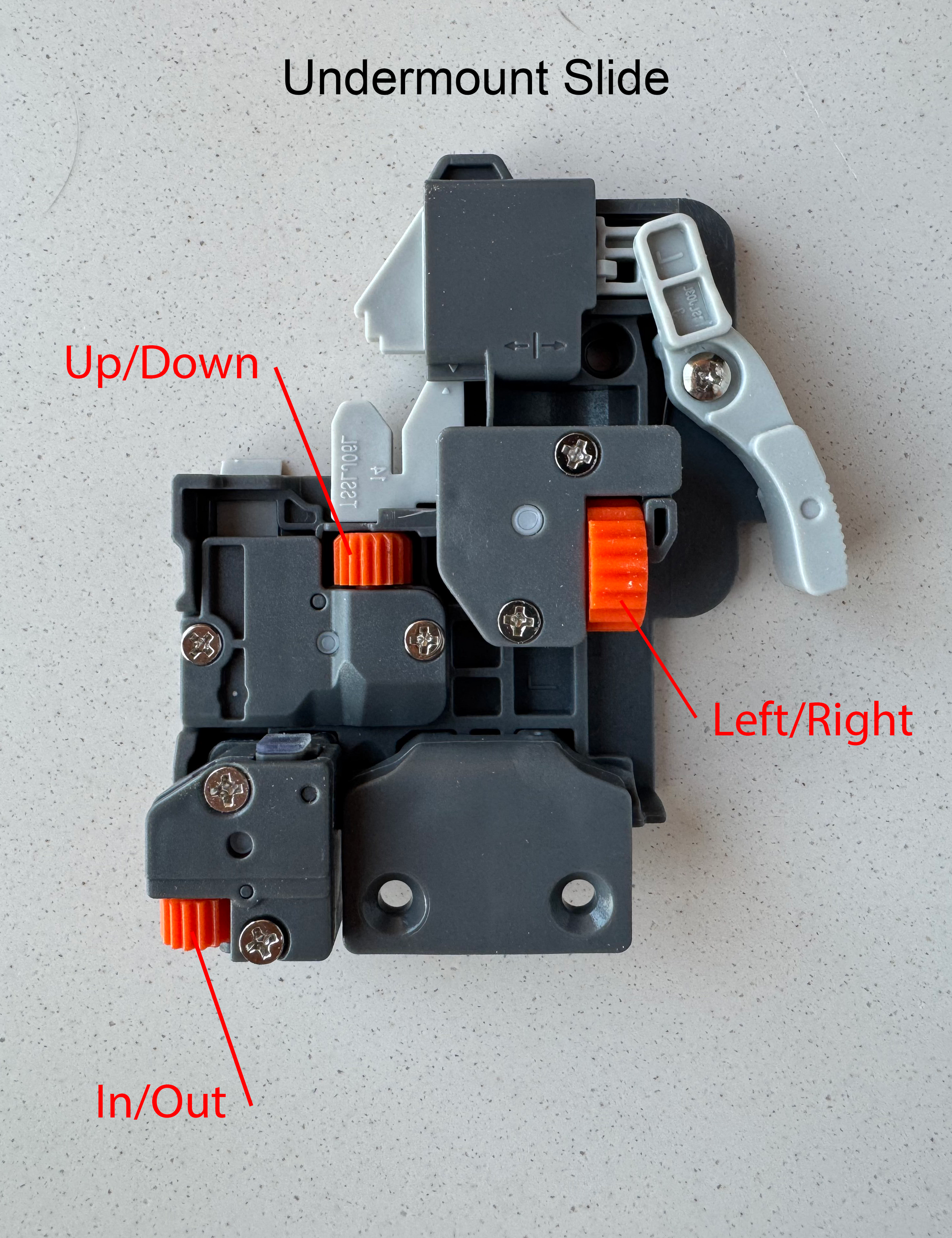 A picture of an undermount slide showing the different parts and adjustment wheels