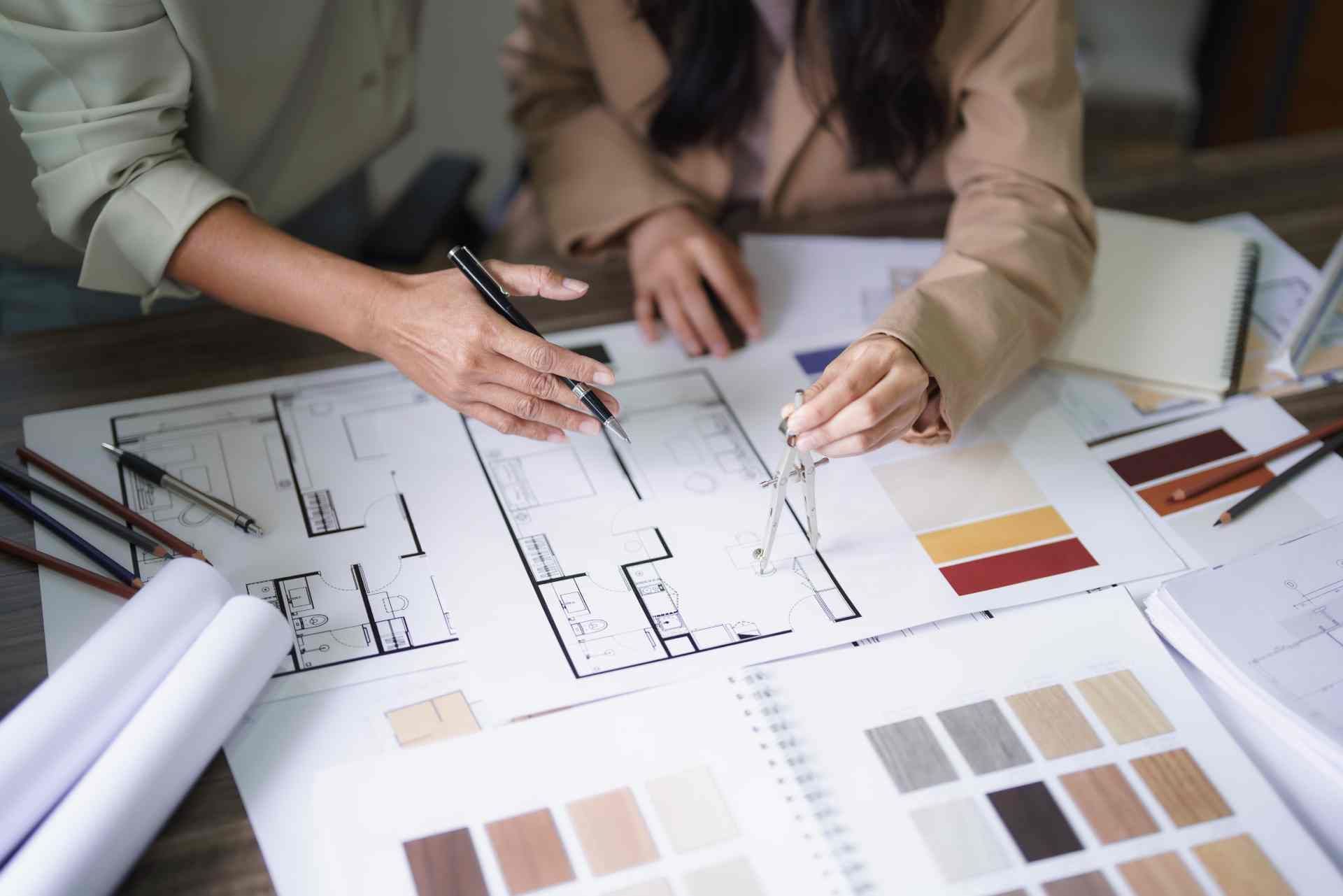 Experienced interior designers working on sketches and color palettes for a client's home renovation at Divine Interiors Group near Lakewood Ranch, Florida (FL)