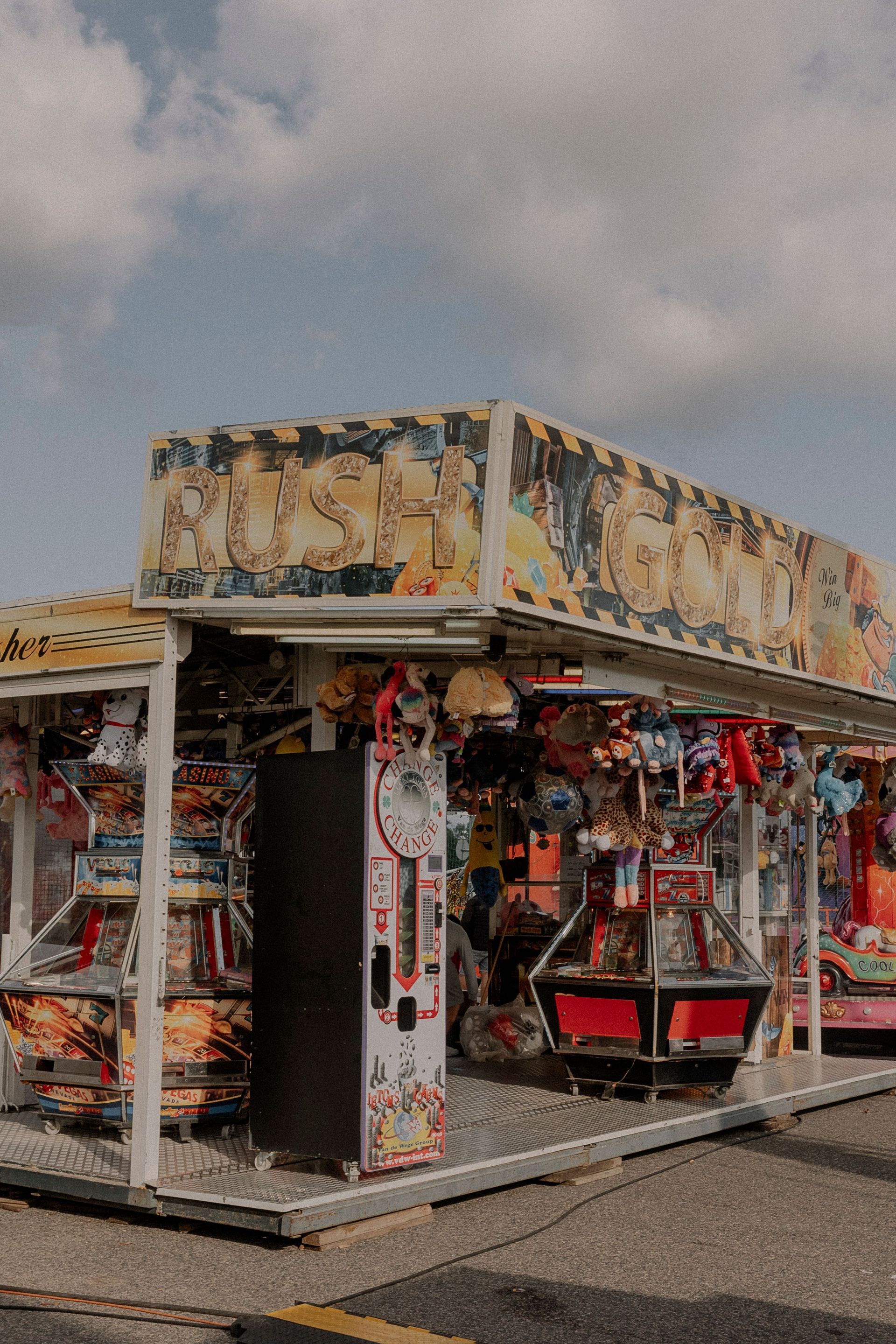 Small colorful kiosk or souvenir stand with red and white trim on a street corner
