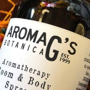 Close-up of a dark bottle with a cream label reading “AROMA G’S Botanica.”