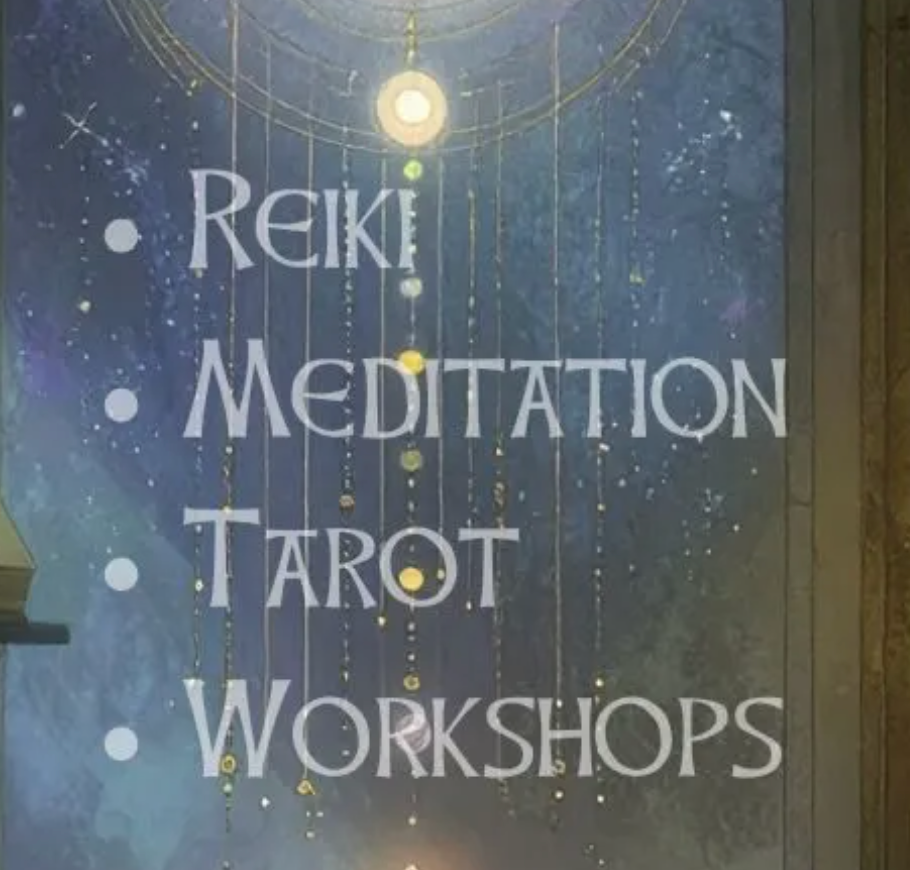 Sign listing Reiki, Meditation, Tarot, and Workshops in white text on a dark blue wall