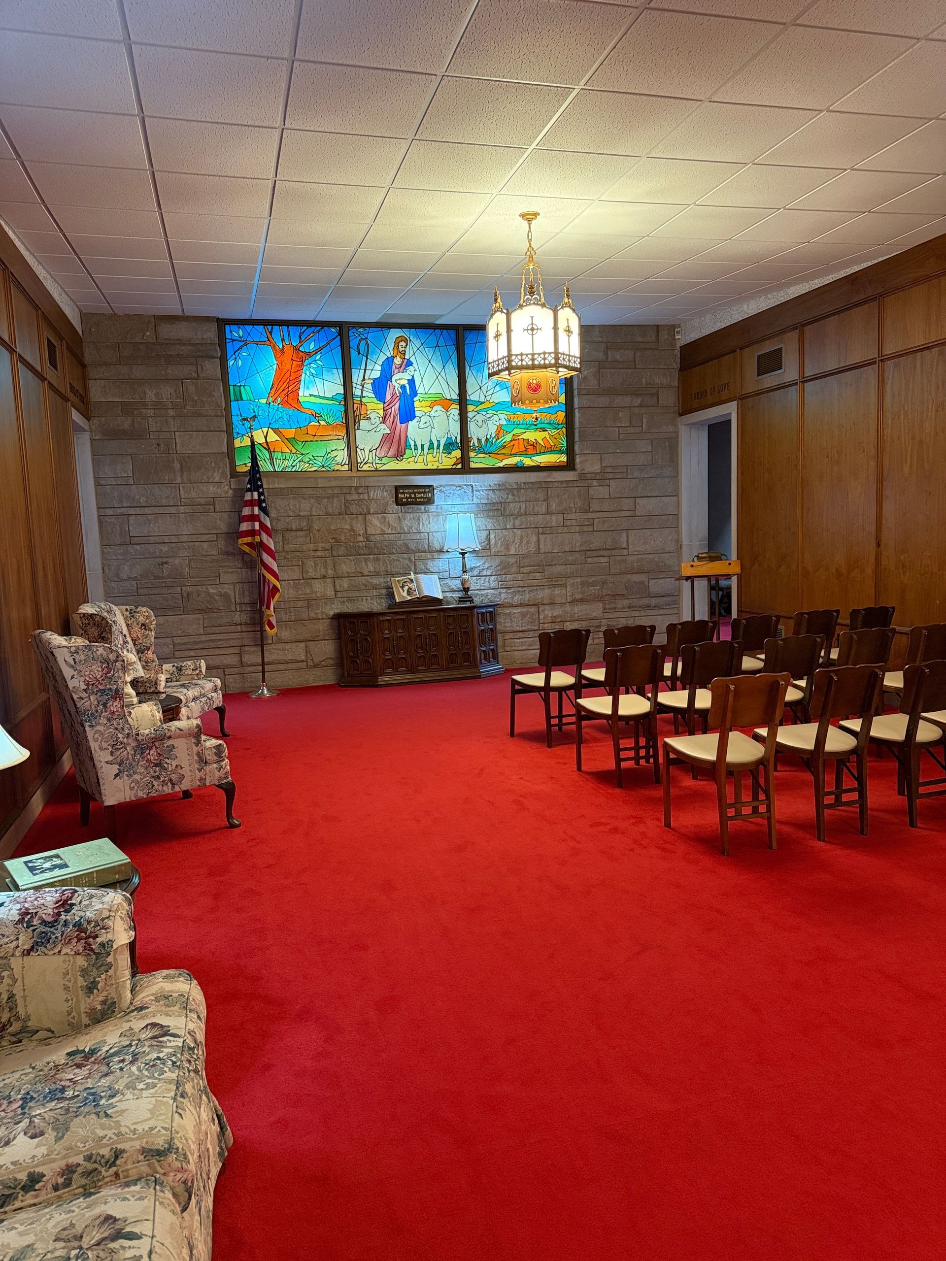 chapel photo with benches, altar, and stained glass
