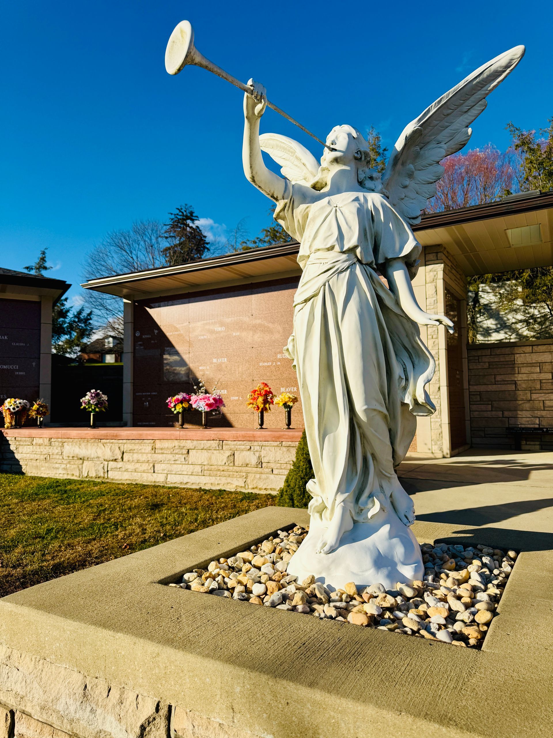 Beautiful photo of an angel statue with a horn in a garden mausoleum