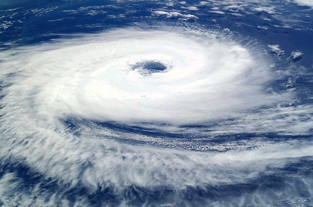 An aerial view of a hurricane with a hole in the middle of it.