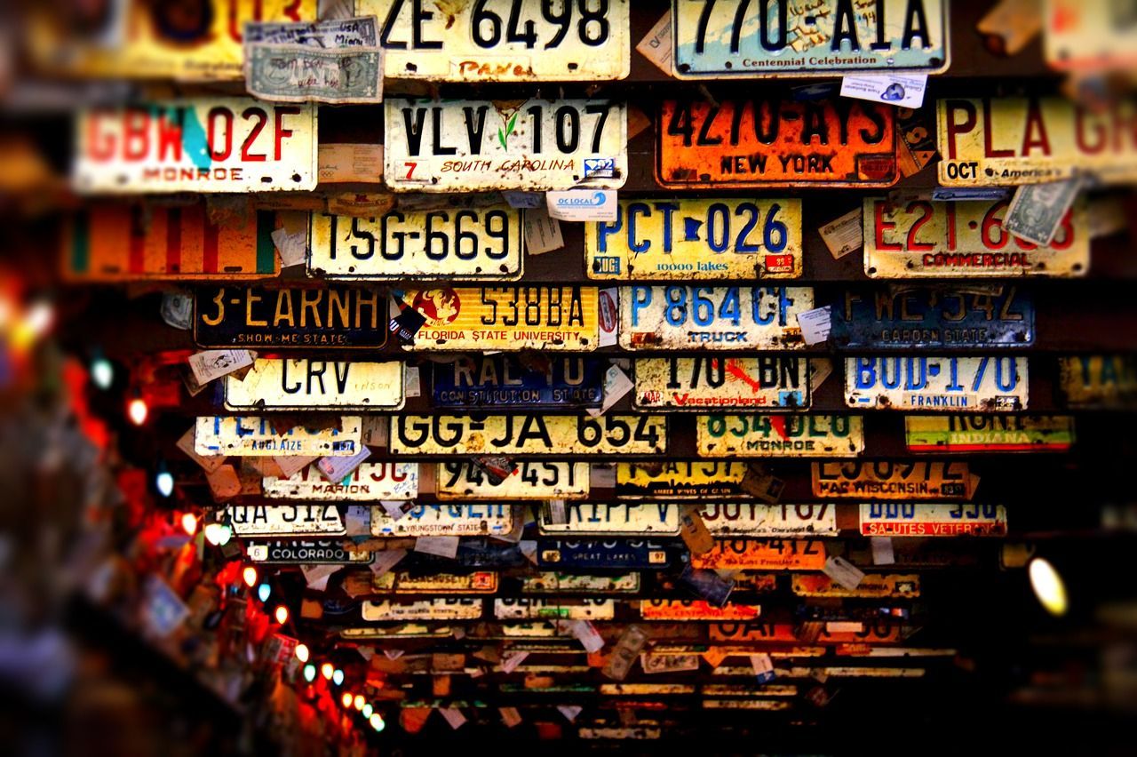 A bunch of license plates are stacked on top of each other