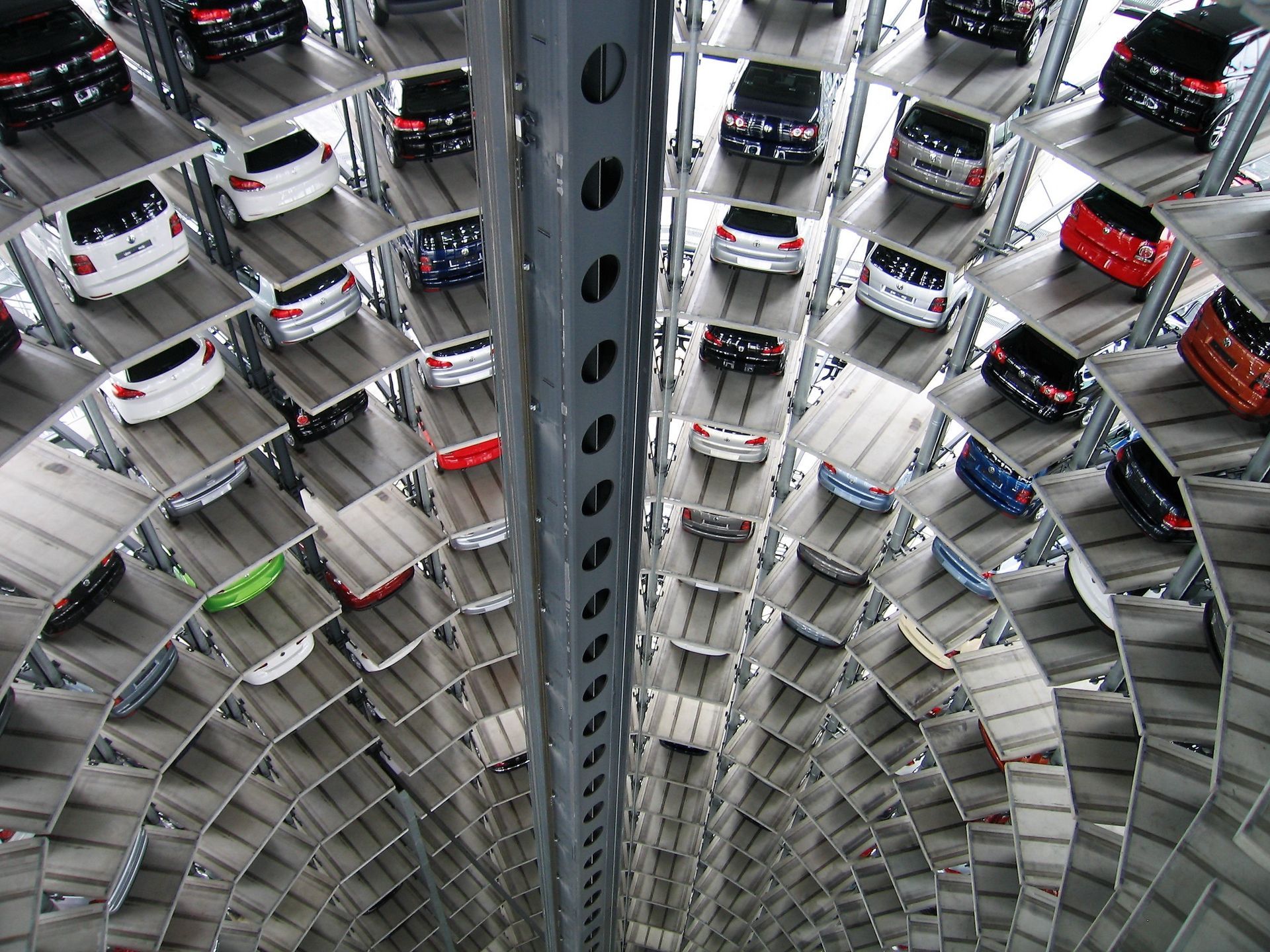 A lot of cars are stacked on top of each other in a parking garage