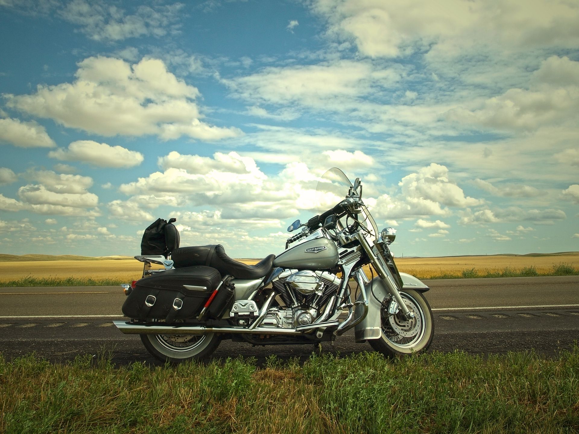 A harley davidson motorcycle is parked on the side of the road