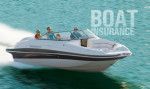 A white boat is floating on top of a body of water.