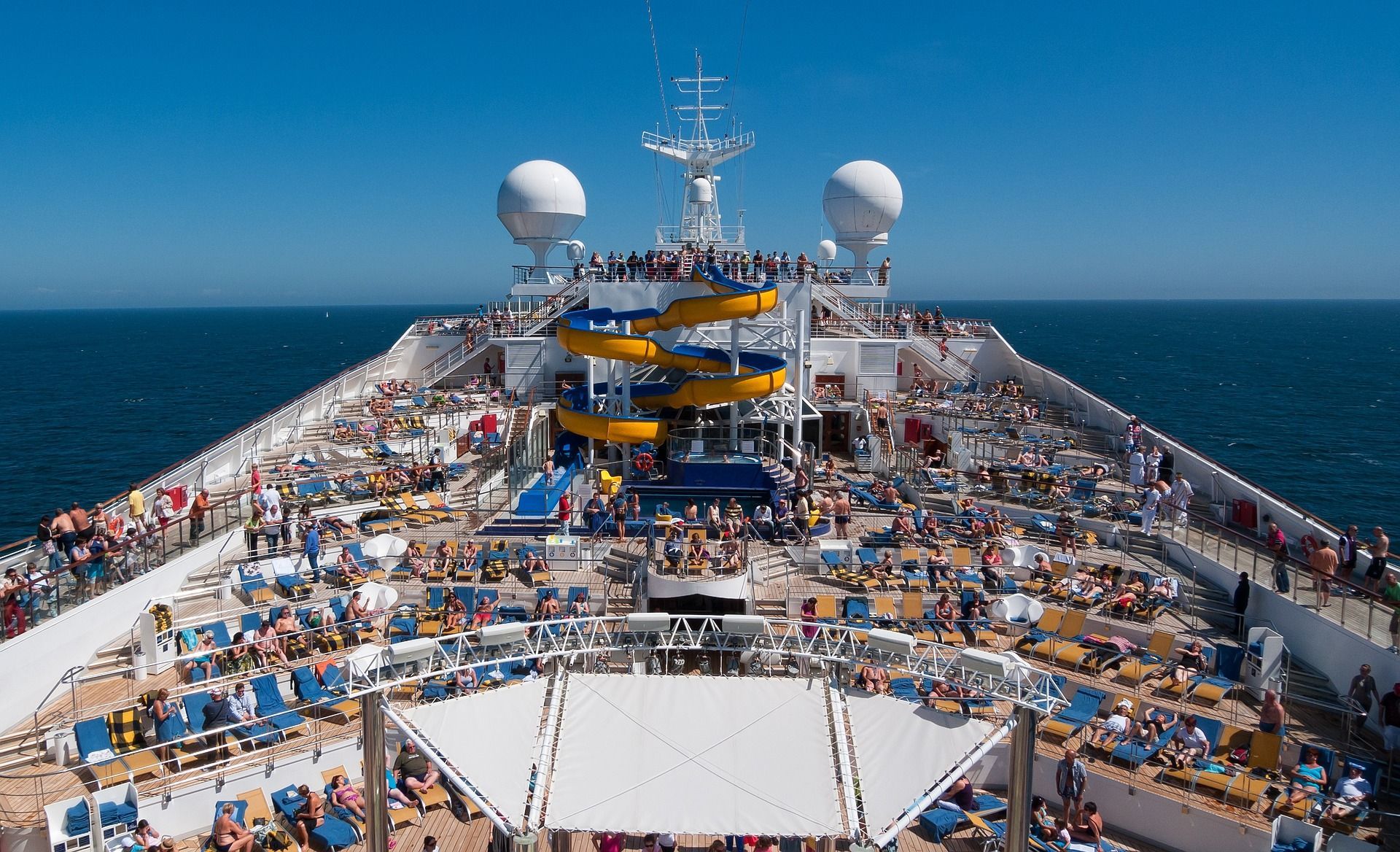 A large cruise ship with a water slide on the deck