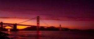 A bridge over a body of water at sunset.
