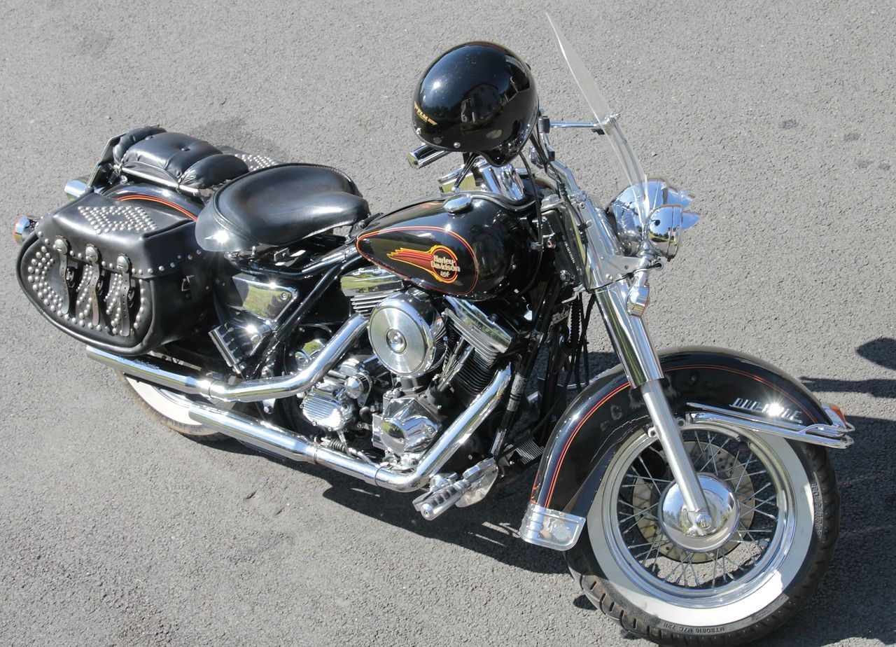 A black harley davidson motorcycle with a helmet on the handlebars