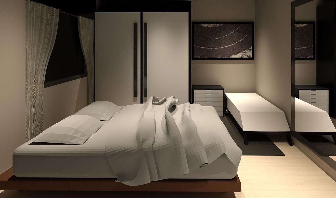 A bedroom with a large bed and a mirror