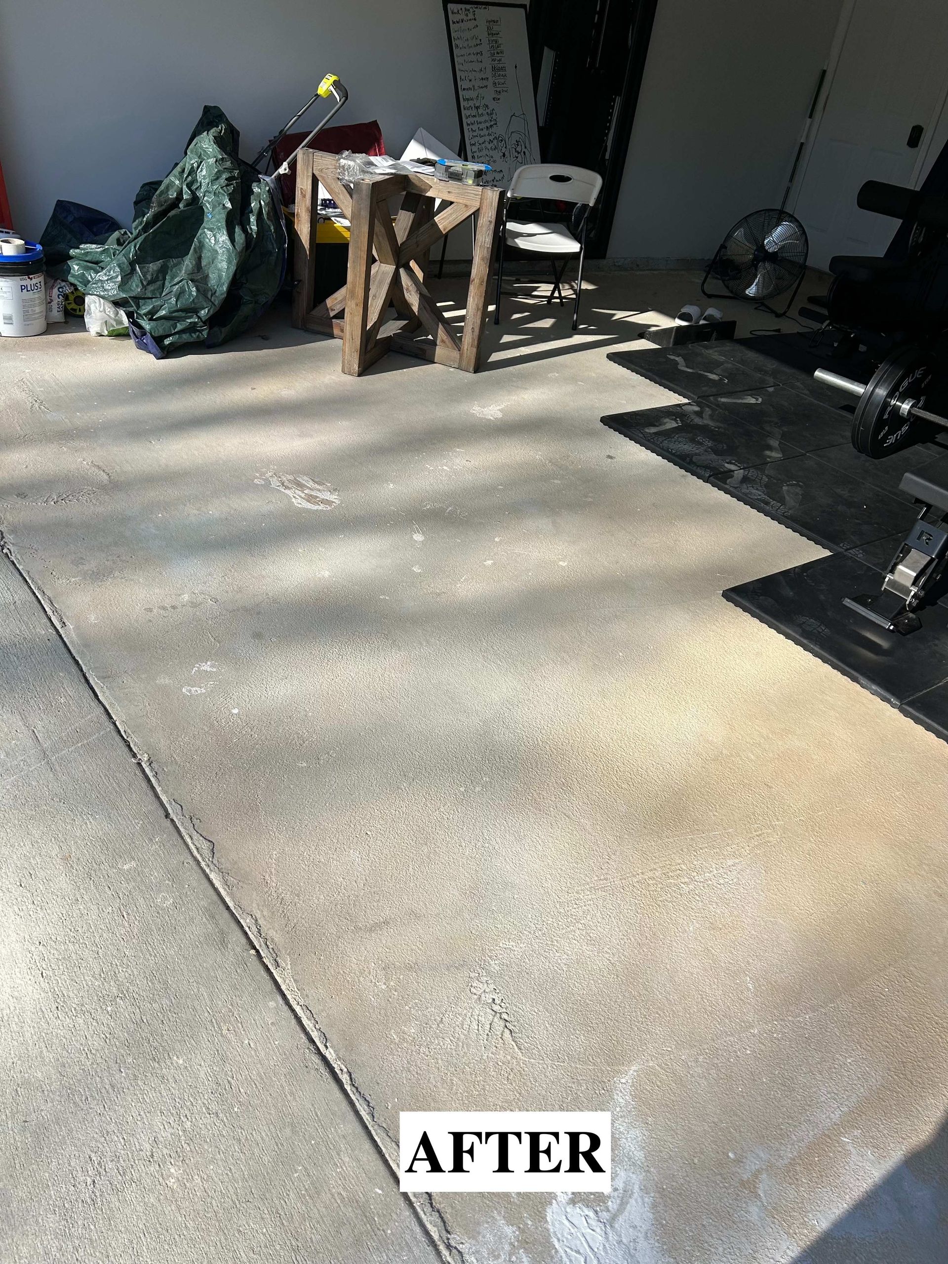 Garage floor after cleaning, with scattered items and strong sunlight shadows.