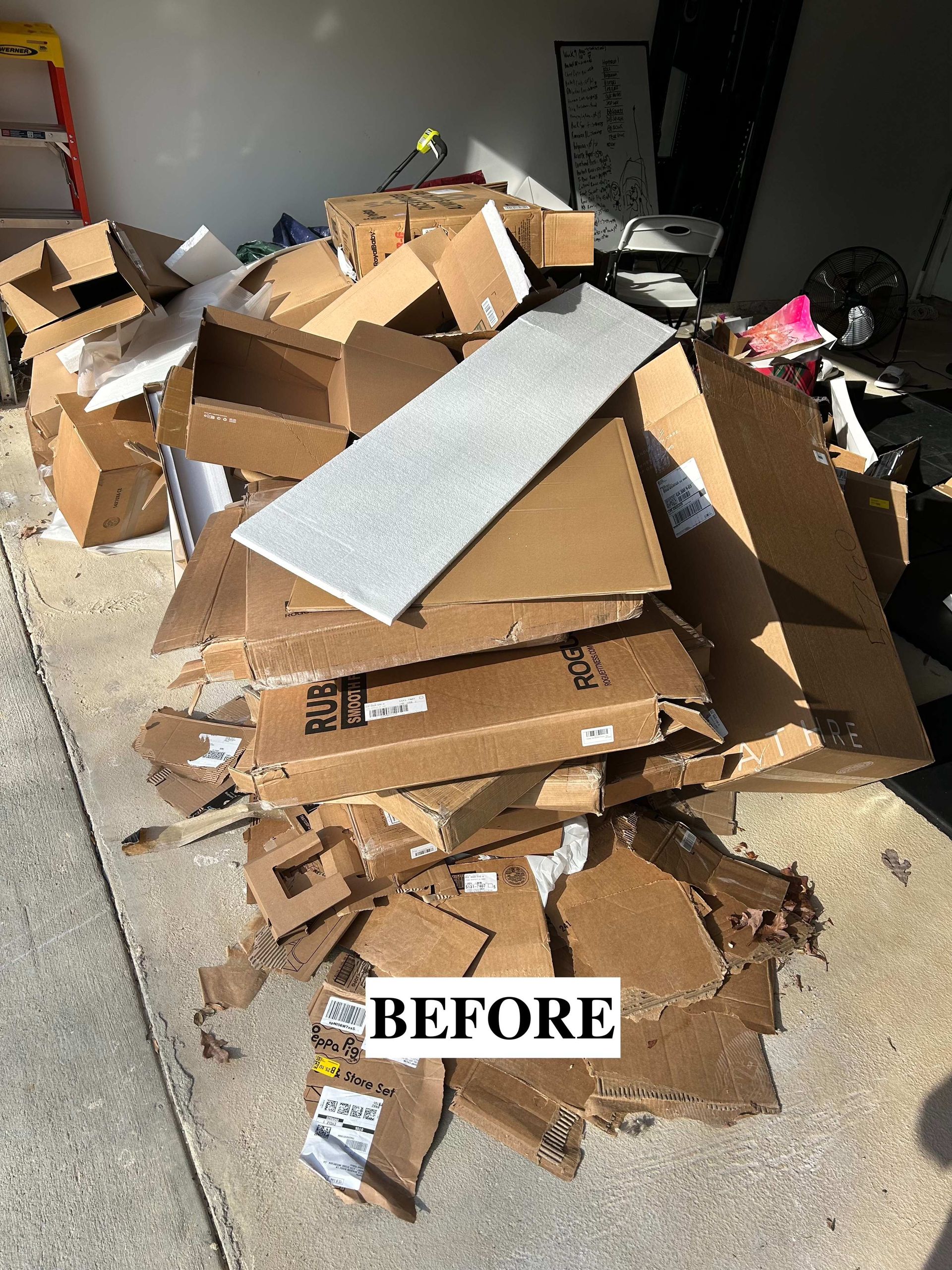 Pile of broken cardboard boxes and packing debris on a floor, labeled “BEFORE.”