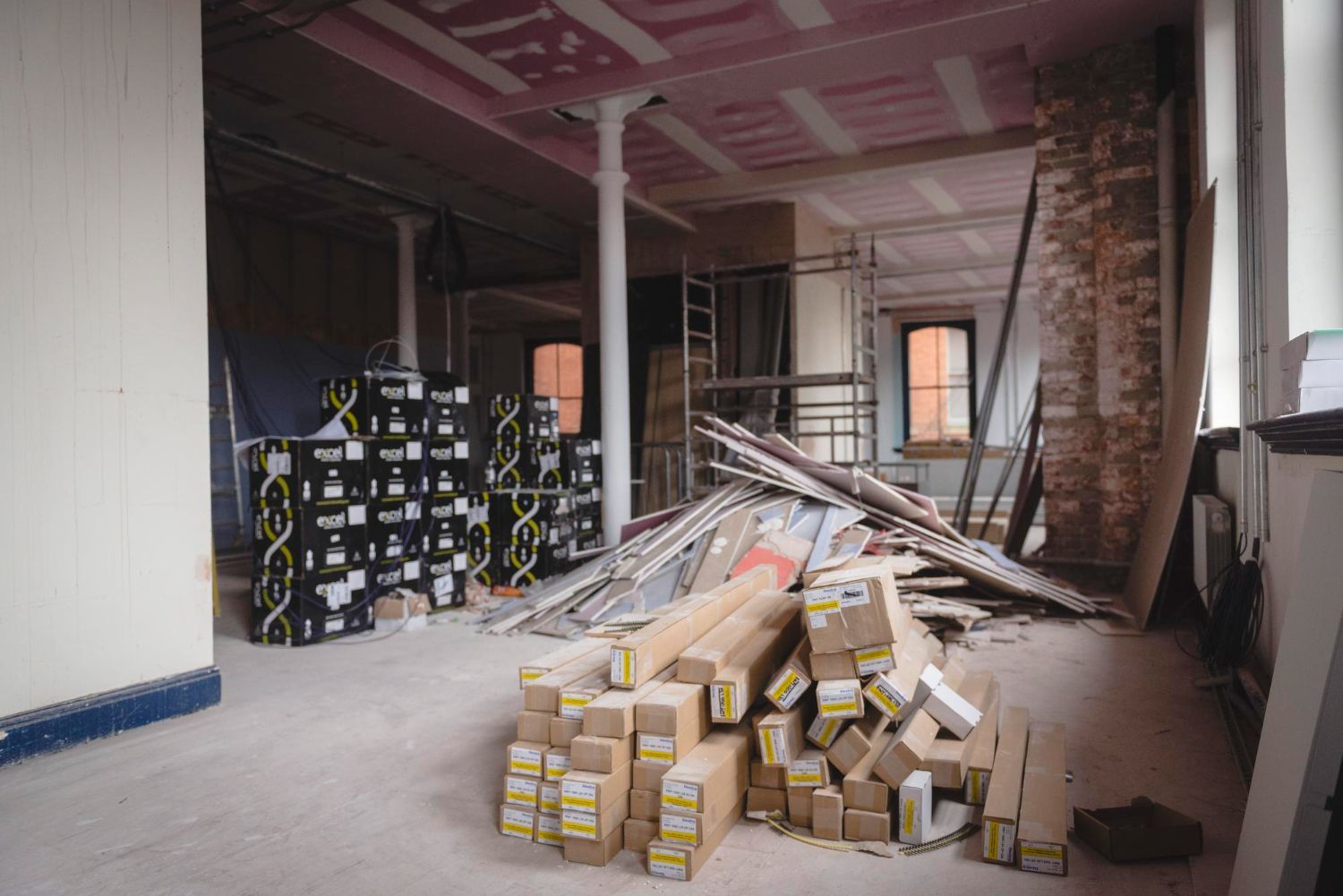 Large pile of drywall scraps lumber cutoffs and building materials inside an active renovation site needing construction debris removal in Smyrna GA