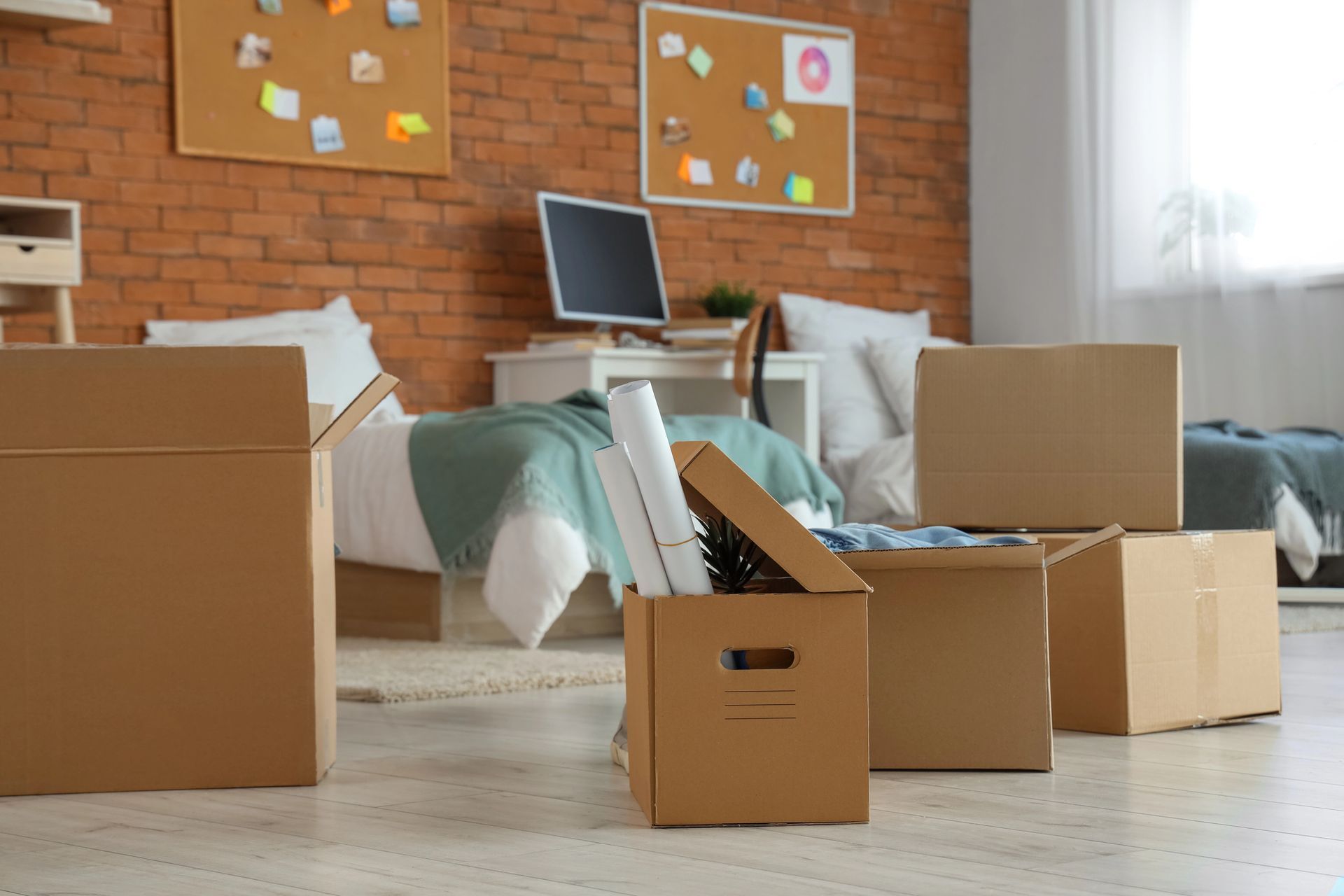 Packed cardboard moving boxes sitting in a residential bedroom during a full house cleanout service in Smyrna GA