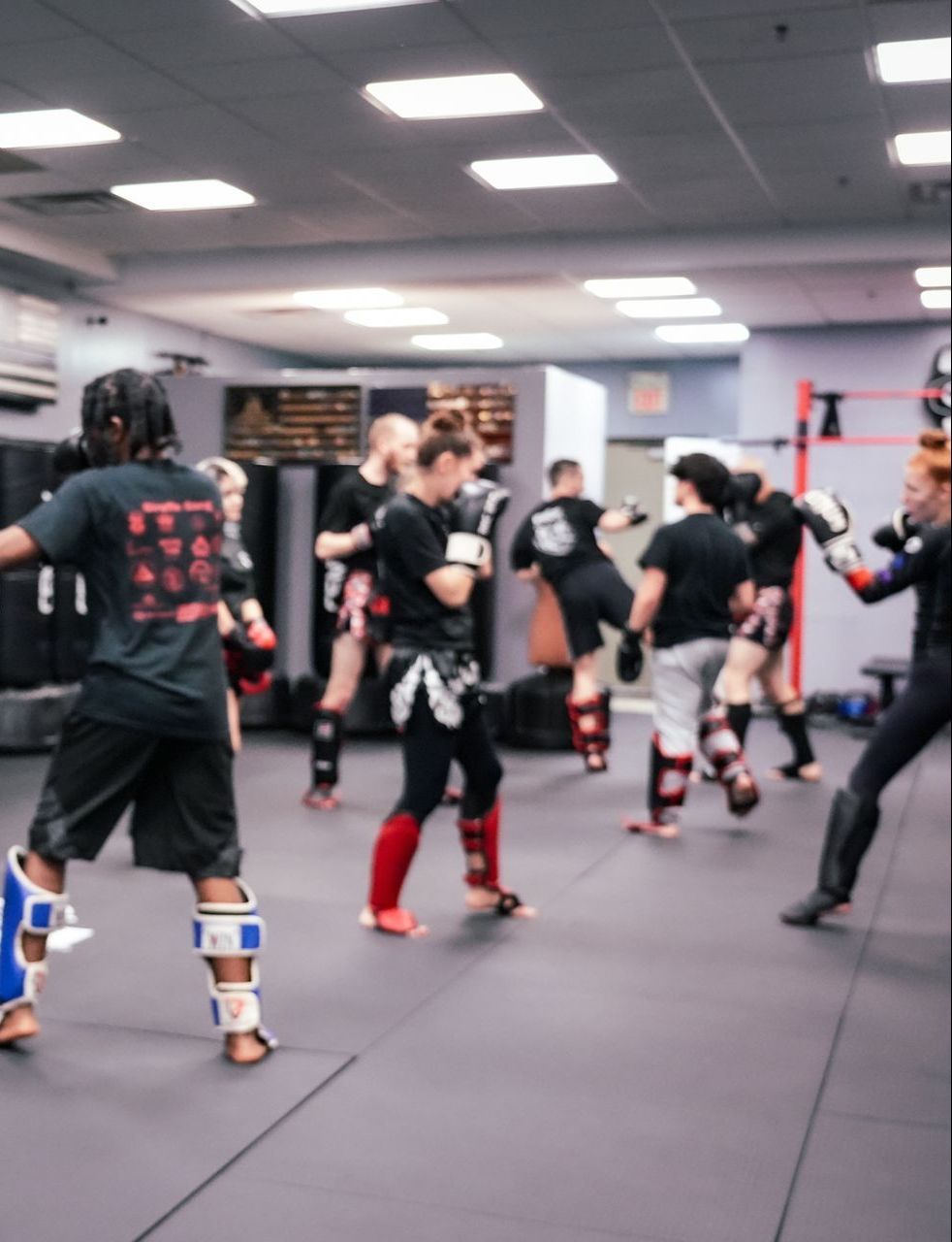 A group of men are practicing martial arts in a gym.