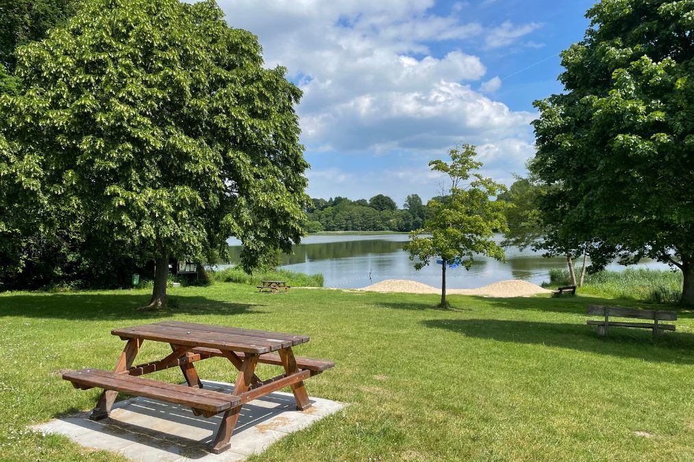 A park with a picnic table and a lac in Exeter.