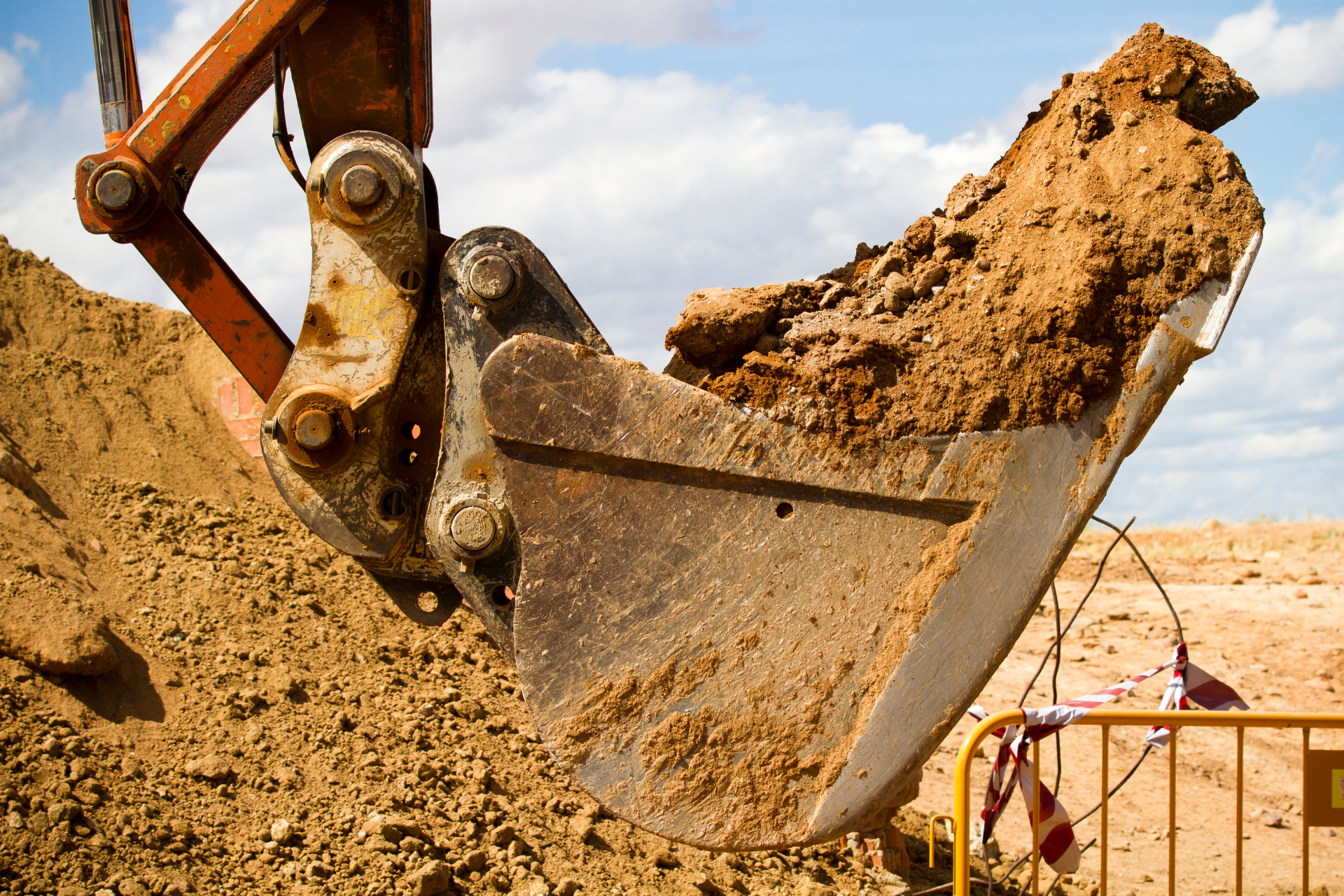 A bulldozer is digging a hole in the dirt.