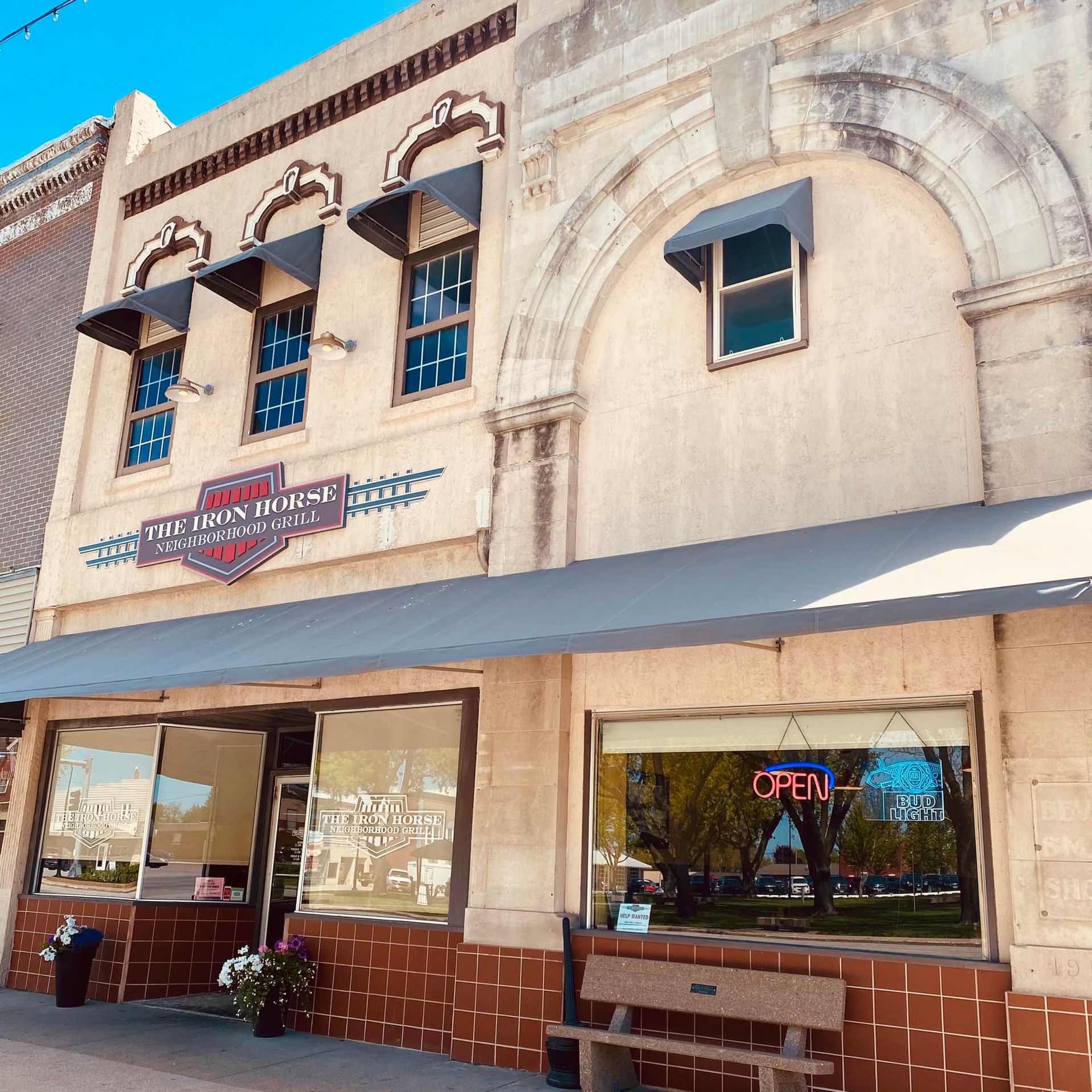 Two-story brick building with awnings and windows; 