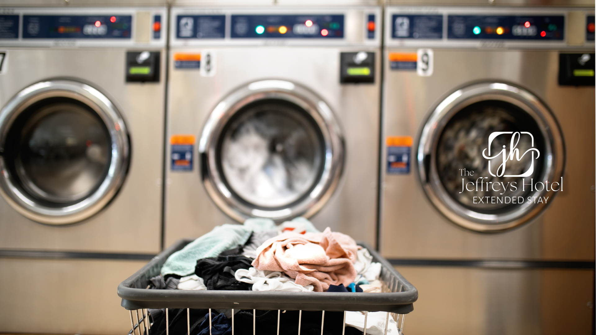 Laundry basket full of clothes in front of three washing machines.