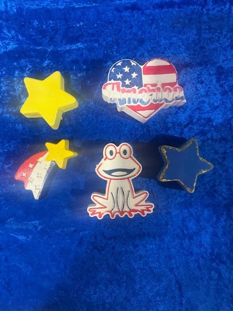 Frog, heart, star, and moon stickers on a blue fabric background