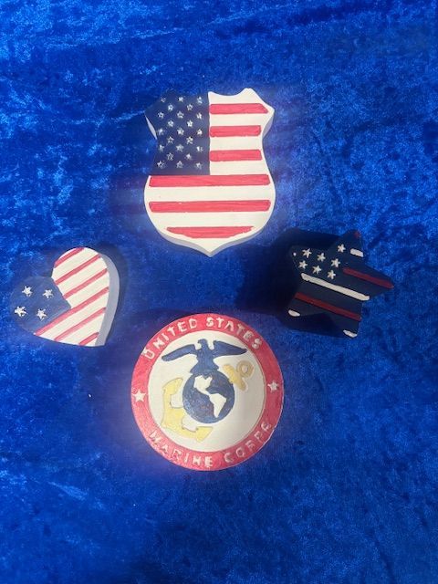 United States-themed pins and a U.S. Coast Guard emblem on blue fabric.