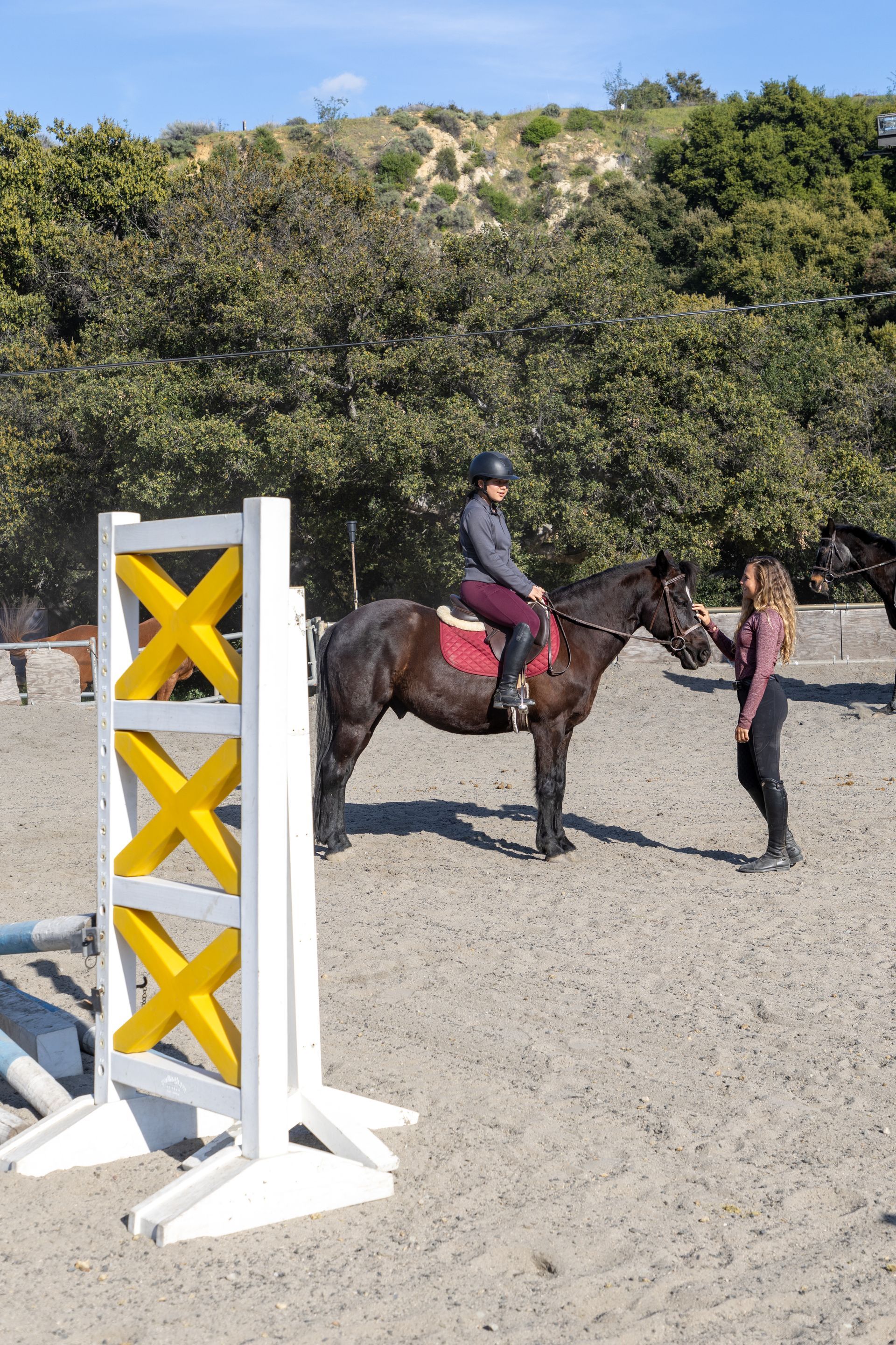 A person riding a horse in a dirt field