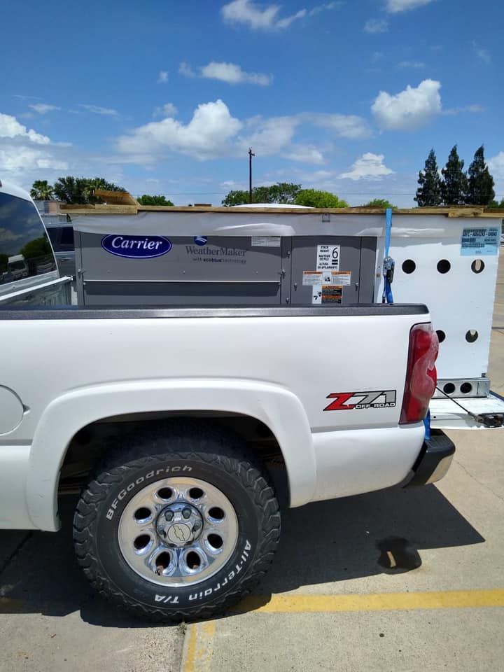A white carrier truck is parked in a parking lot