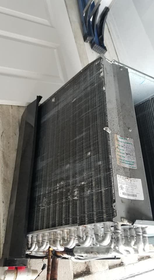 A close up of a refrigerator 's cooling system in a garage.