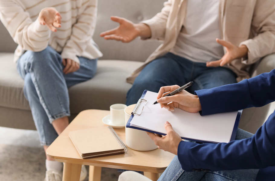 Hands resting calmly near papers on a table