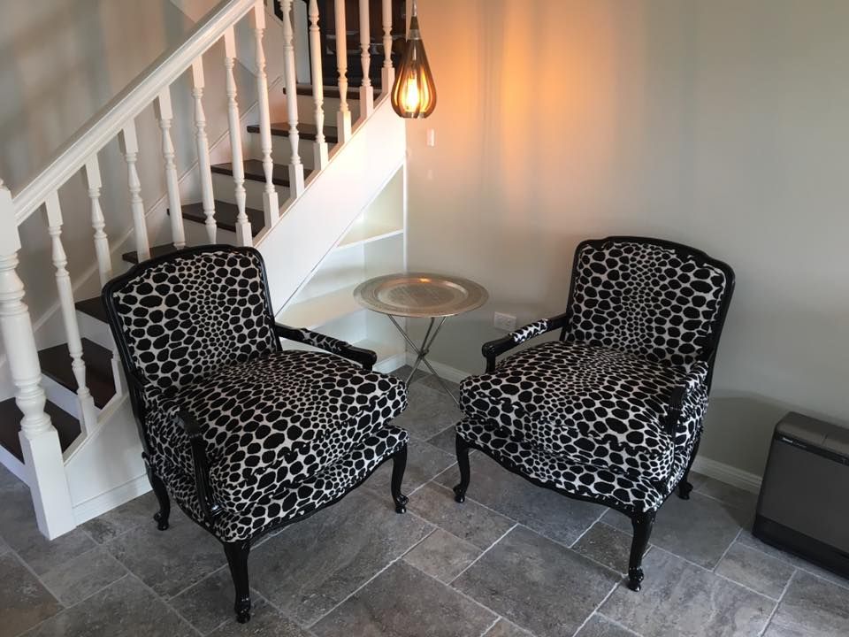 Two Leopard Print Chairs Are Sitting Next to Each Other in Front of A Staircase — Metreson Upholstery In Thirroul, NSW