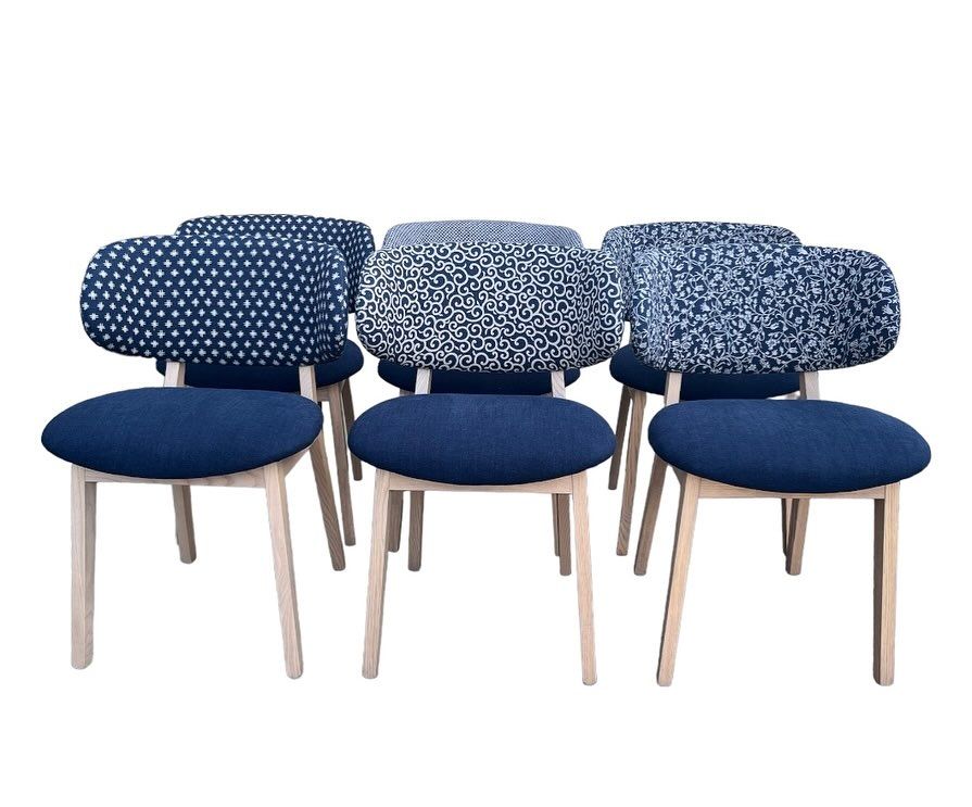 A Group of Chairs Are Lined up In a Row on A White Background — Metreson Upholstery In Unanderra, NSW